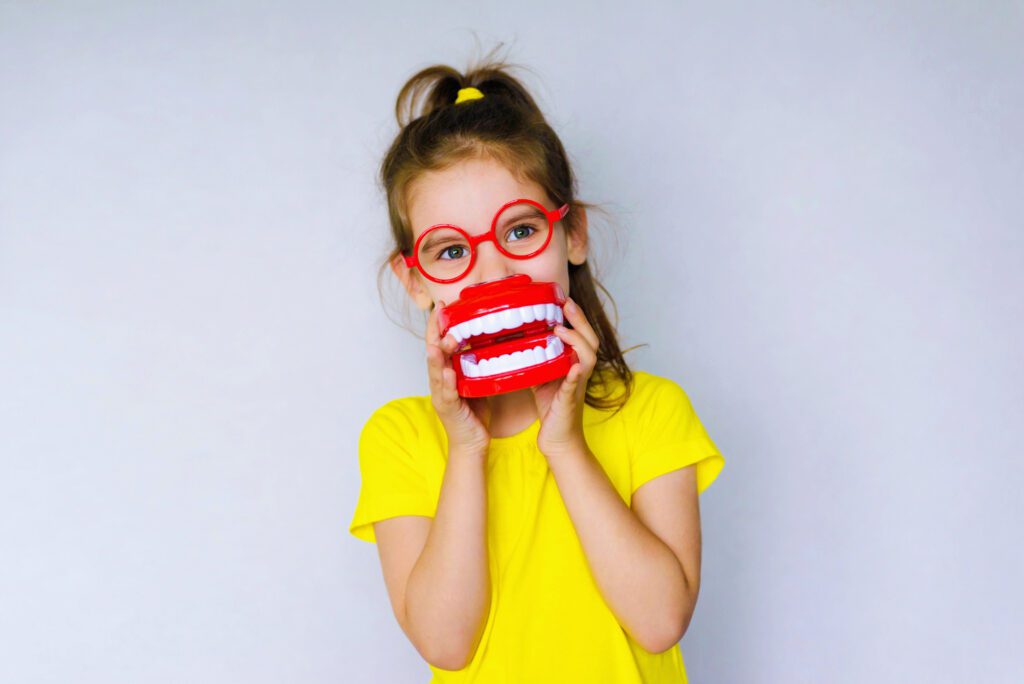 Little,Funny,Girl,Kid,With,Toothbrush,,Dental,Mockup,(jaw),,Red