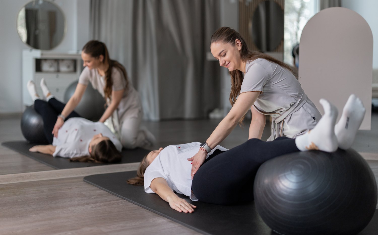 A physical therapist assessing a patient's abdomen and pelvis during a pelvic health appointment.