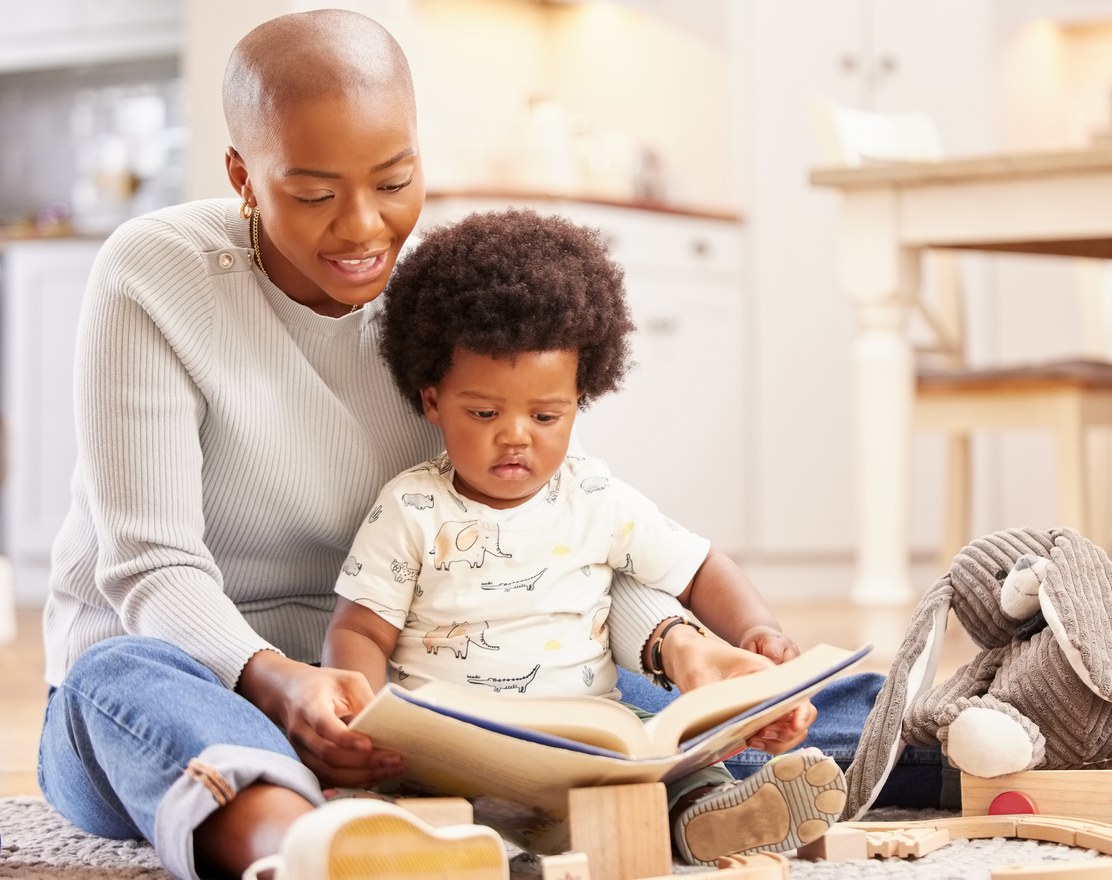 A parent reading a picture book with a toddler