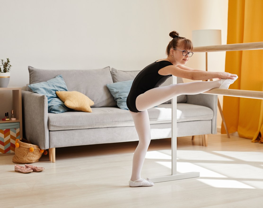 A girl practicing at a ballet barre at home