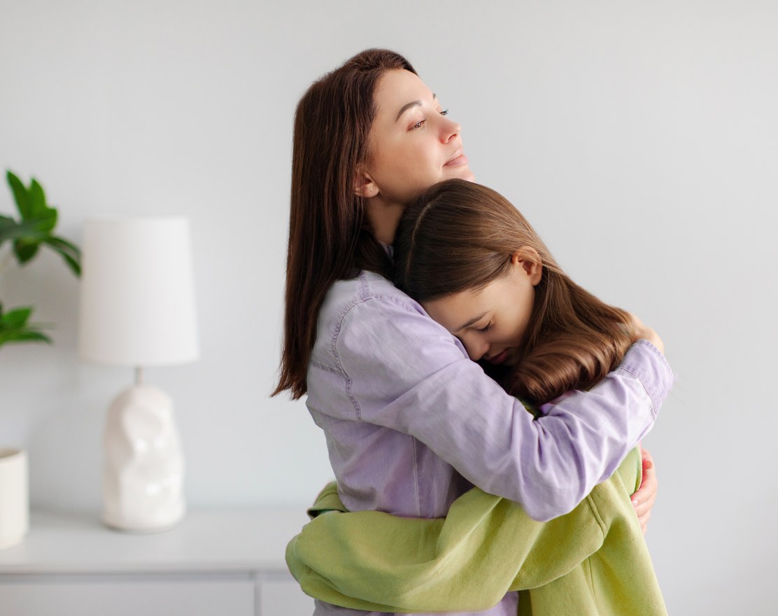 A parent holding and comforting an upset child